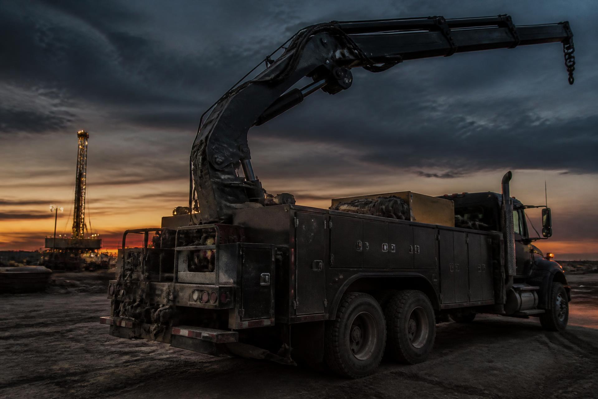 Mechanics service truck with a hydraulic boom crane on a West Texas job site